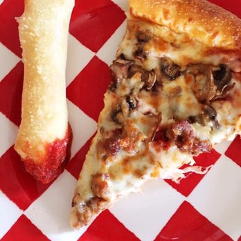 Frankie's Pizza - Slice of sausage mushroom pizza with one of their breadsticks dipped in marinara. - Pizza Near Me - Bonney Lake, Washington Frankie's Pizza - Slice of sausage mushroom pizza with one of their breadsticks dipped in marinara. - Pizza Near Me - Bonney Lake, Washington