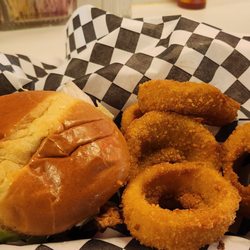 Brian's Cheesesteaks - Fried chicken sandwich on a big bun with onion rings.