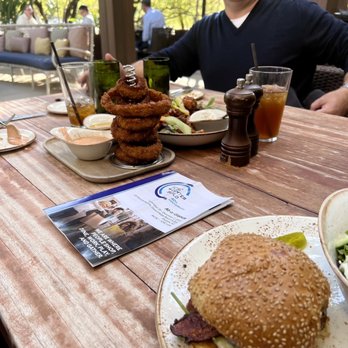 Meritage - An Urban Tavern - a man sitting at a table with a sandwich and salad - Lounges Near Me - Phoenix, Arizona Meritage - An Urban Tavern - a man sitting at a table with a sandwich and salad - Lounges Near Me - Phoenix, Arizona