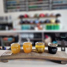 three different types of beer on a wooden tray three different types of beer on a wooden tray