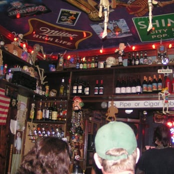 Red Door East - a man in a green hat in a bar - Dive Bars Near Me - Nashville, Tennessee