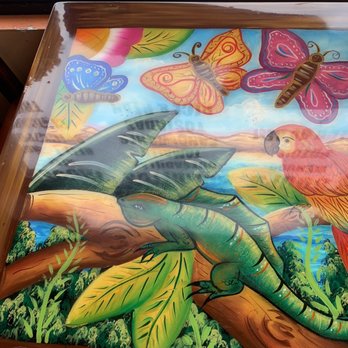 San Marcos - a painting of a parrot and a butterfly - Mexican Near Me - Toledo, Ohio San Marcos - a painting of a parrot and a butterfly - Mexican Near Me - Toledo, Ohio