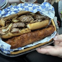 Filet mignon sandwich with grilled onions, mushrooms, on garlic bread with a large fried potato wedge that they added on for free