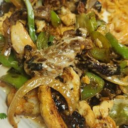Texas Rice with shrimp, chicken & beef smothered in cheese sauce and served over rice.