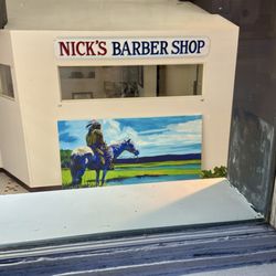 Nick's Barber Shop - You can see the sign if you crouch at the window right next to the basement entrance