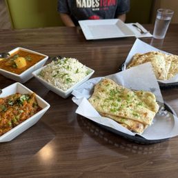 Family meal with two vegetarian curries and garlic and chili naan Family meal with two vegetarian curries and garlic and chili naan