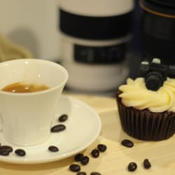 Cafféra Photo and Coffee - Caffera's espresso and cupcake, with some cute lens tumblers in the background.