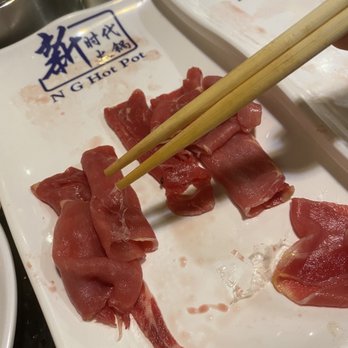 New Generation Hot Pot - Plastic hanging from the chopstick and laying on the plate. Bug is in the background (this was taken before I noticed the bug) - Hot Pot Near Me - Towson, Maryland