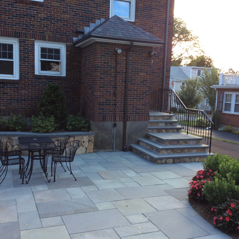 John's Landscape Services - a patio with a table and chairs - Landscaping Near Me - Arlington, Massachusetts John's Landscape Services - a patio with a table and chairs - Landscaping Near Me - Arlington, Massachusetts