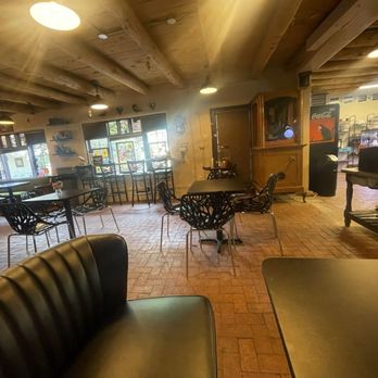 Blackbird Coffee House - New seating area - A coffee shop interior featuring wooden ceiling beams, multiple tables with chairs, and windows allowing natural light. - Coffee & Tea Near Me - Albuquerque, New Mexico
