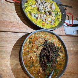 two bowls of food on a wooden table two bowls of food on a wooden table