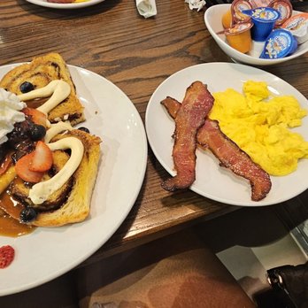 Another Broken Egg Cafe - Cinnamon roll French toast, bacon and scrambled eggs - American Near Me - Orlando, Florida