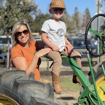Bishop's Pumpkin Farm - Me and my grandson letting him pretend drive a big old tractor - Christmas Trees Near Me - Wheatland, California Bishop's Pumpkin Farm - Me and my grandson letting him pretend drive a big old tractor - Christmas Trees Near Me - Wheatland, California