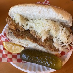 Braumeister Bierhalle - Schnitzel with fried onions and sauerkraut on bun with a pickle