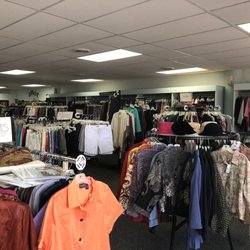 Between Friends Consignment - Clothing organized by type, then size, then color.