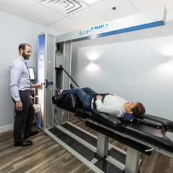 Northern Nevada Chiropractic - Dr. Welch helps a Spinal Decompression patient on the best decompression table on the market.