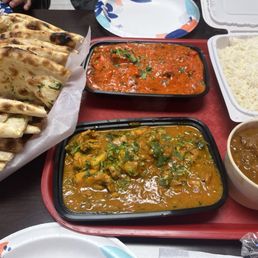 Chicken curry, chicken tikka masala and lamb curry with garlic naan and basmati rice. Chicken curry, chicken tikka masala and lamb curry with garlic naan and basmati rice.