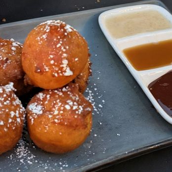 Postino Del Mar - Hot donut dots dessert with a variety of dipping sauces (vanilla, caramel and chocolate). - Wine Bars Near Me - San Diego, California Postino Del Mar - Hot donut dots dessert with a variety of dipping sauces (vanilla, caramel and chocolate). - Wine Bars Near Me - San Diego, California