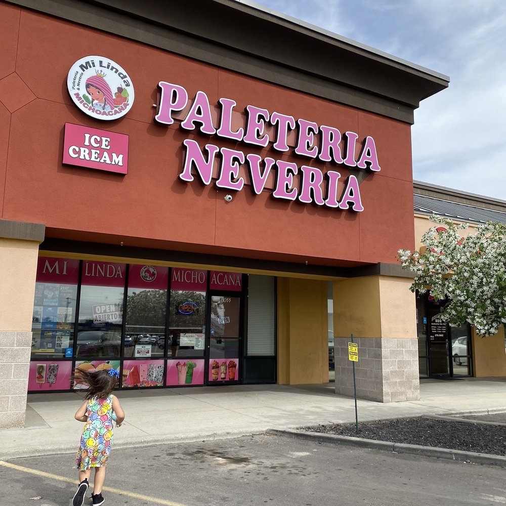 a girl walking in front of a store