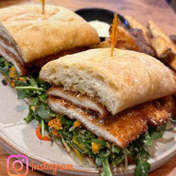 Garrison Kitchen + Cocktails - chicken cutlet sandwich - arugula, pickled pepper, olive, pecorino, lemon, ciabatta - American Near Me - Metairie, Louisiana Garrison Kitchen + Cocktails - chicken cutlet sandwich - arugula, pickled pepper, olive, pecorino, lemon, ciabatta - American Near Me - Metairie, Louisiana