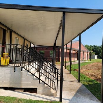Specialist Aluminum - A screened porch with a solid covered roof, framed walls, wood deck flooring, and outdoor furniture overlooks a residential b... - Patio Coverings Near Me - Pelzer, South Carolina Specialist Aluminum - A screened porch with a solid covered roof, framed walls, wood deck flooring, and outdoor furniture overlooks a residential b... - Patio Coverings Near Me - Pelzer, South Carolina