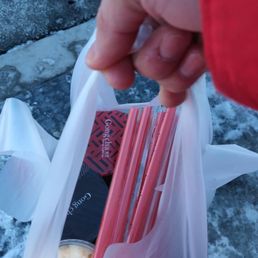 a person holding a bag of food