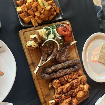 Kababji Grill - Lamb chop skewers, Tawook Skewer and Beef Kafta Skewer. Spicy potatoes on the side with hummus and pita - Mediterranean Near Me - Anaheim, California Kababji Grill - Lamb chop skewers, Tawook Skewer and Beef Kafta Skewer. Spicy potatoes on the side with hummus and pita - Mediterranean Near Me - Anaheim, California