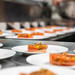 En Place Catering - Tomato Tartar with Watermelon and Balsamic Reduction being plated for a multi-course plated dinner.