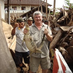 Yak Arts - Bob, again, on one of his buying trips to Bali, Indonesia, holding a Monitor lizard.