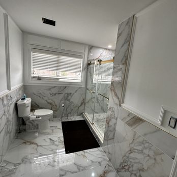 Sulaiman GC - a bathroom with a toilet and shower - Flooring Near Me Sulaiman GC - a bathroom with a toilet and shower - Flooring Near Me