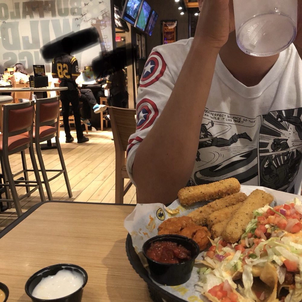 Buffalo Wild Wings - Our waiter seems to be the only one working. Two employees sit and chat for nearly the entirety of our stay at BWW. - Chicken Wings Near Me - Carson, California