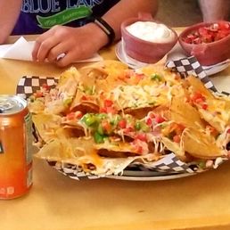 a plate of nachos and a can of soda a plate of nachos and a can of soda
