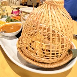 Chicken satay in this birdhouse like plating
