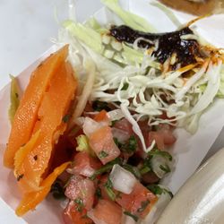 Three garnishes: pico de gallo, pickled carrots, and a deliciously different chile sauce