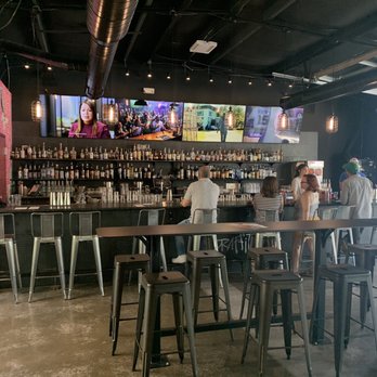 Graffiti : Spirits, Axes & Art - a man sitting at a bar - Axe Throwing Near Me - Cary, North Carolina Graffiti : Spirits, Axes & Art - a man sitting at a bar - Axe Throwing Near Me - Cary, North Carolina