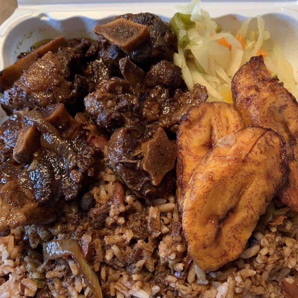 Golden Krust Caribbean Restaurant - Braised Oxtail with black beans and rice and a side of plantains - Caribbean Near Me - Stratford, Connecticut Golden Krust Caribbean Restaurant - Braised Oxtail with black beans and rice and a side of plantains - Caribbean Near Me - Stratford, Connecticut