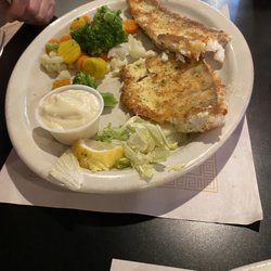Lakeside Bar And Grill - Half eaten Walleye fish entree with veggies.