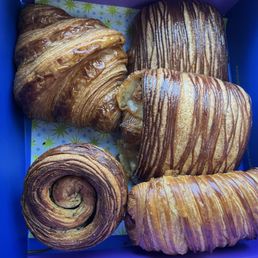 Croissant (top left), 2 cubanos (top and middle right), black sesame kouign amann (bottom left), pain au chocolat (bottom right) Croissant (top left), 2 cubanos (top and middle right), black sesame kouign amann (bottom left), pain au chocolat (bottom right)