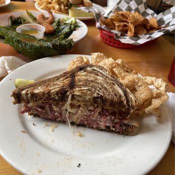 Tavern On The James - Rueben sandwich with pork rinds side (front), steamed shrimp appetizer (back left), house made chips (back right) - American Near Me - Scottsville, Virginia Tavern On The James - Rueben sandwich with pork rinds side (front), steamed shrimp appetizer (back left), house made chips (back right) - American Near Me - Scottsville, Virginia