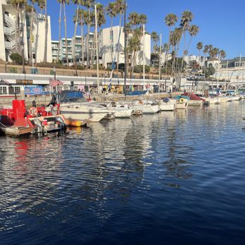 Redondo Beach Pier - wharf with small boats with shops and tall residential buildings behind them during the day - Souvenir Shops Near Me - Redondo Beach, California Redondo Beach Pier - wharf with small boats with shops and tall residential buildings behind them during the day - Souvenir Shops Near Me - Redondo Beach, California