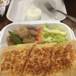 Carne Asada quesadilla with a side of sour cream Carne Asada quesadilla with a side of sour cream