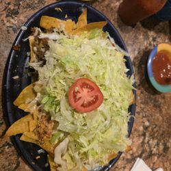 La Hacienda - Nachos supreme with sour cream and beans on the side with extra lettuce