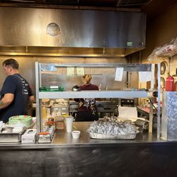 Two people turning out excellent St.Louis BBQ!