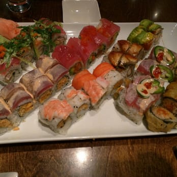Sushi Love - So much sushi!!! Dynamite, Fire, Sweet Dragon, Crunchy, Red Dragon, Maguro Tartar, and Champion (right to left, back to front) - Sushi Bars Near Me - Durham, North Carolina