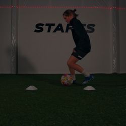 Joga Soccer Academy - Youth soccer player dribbling at joga soccer academy indoor facility in bellingham, wa