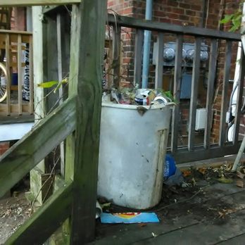 Old World Properties - Overflowing trash receptacle stored on porch for a minimum of several years. - Property Management Near Me - Richmond, Virginia Old World Properties - Overflowing trash receptacle stored on porch for a minimum of several years. - Property Management Near Me - Richmond, Virginia