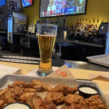 Buffalo Wild Wings - a glass of beer and a tray of buffalo wings - American Near Me - Dublin, Ohio Buffalo Wild Wings - a glass of beer and a tray of buffalo wings - American Near Me - Dublin, Ohio