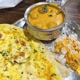 Malai Kofta: gummy, under-seasoned vegetarian dumplings in a creamy cashew sauce with garlic naan and basmati rice cut with cheaper rice. Malai Kofta: gummy, under-seasoned vegetarian dumplings in a creamy cashew sauce with garlic naan and basmati rice cut with cheaper rice.