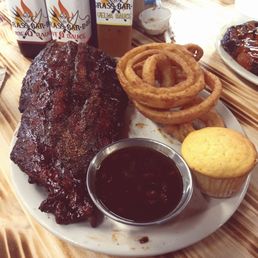 Half rack of perfectly bite-thru Pork Ribs, crispy giant onion rings, smokey BBQ Baked Beans and Corn Bread. No sauce is needed! Half rack of perfectly bite-thru Pork Ribs, crispy giant onion rings, smokey BBQ Baked Beans and Corn Bread. No sauce is needed!
