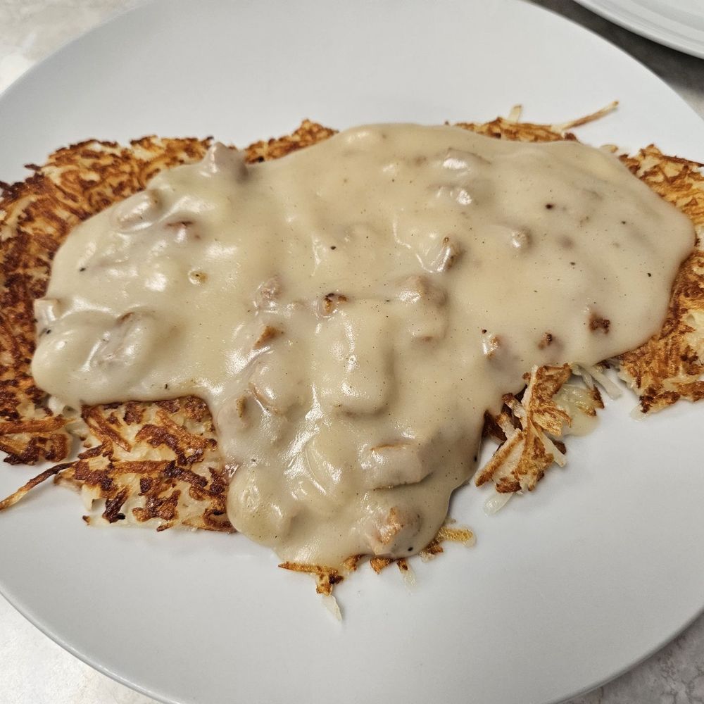Copper Cove Restaurant - Side order of hashbrowns with country gravy on top - American Near Me - Copperopolis, California